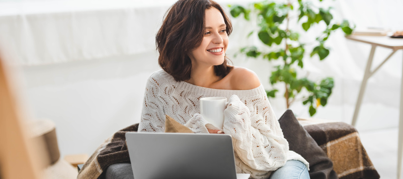 attractive smiling girl with cup of coffee using l 2024 11 18 19 51 24 utc